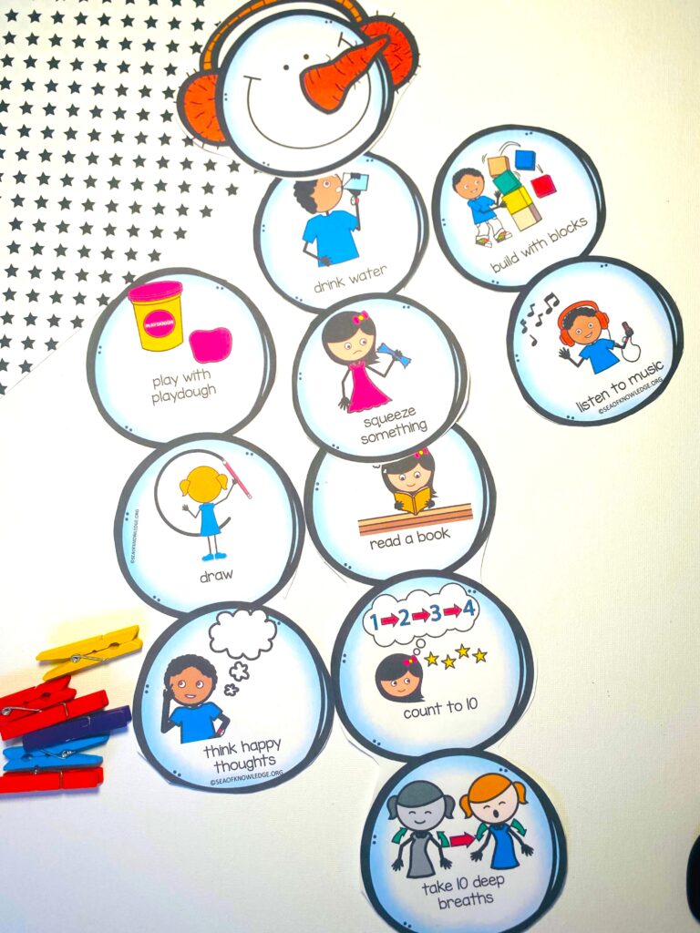 Completed Snowman Calm Down Clip Chart hanging on the wall with colorful clothespins attached, each labeled with a child’s name