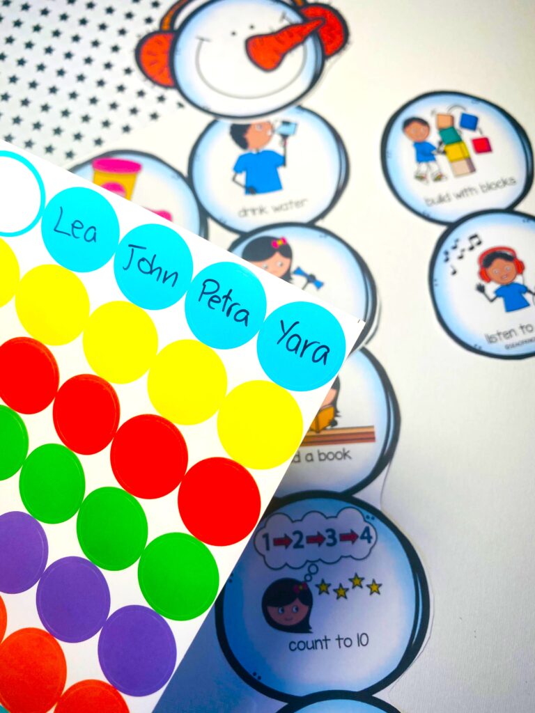 Completed Snowman Calm Down Clip Chart hanging on the wall with colorful clothespins attached, each labeled with a child’s name