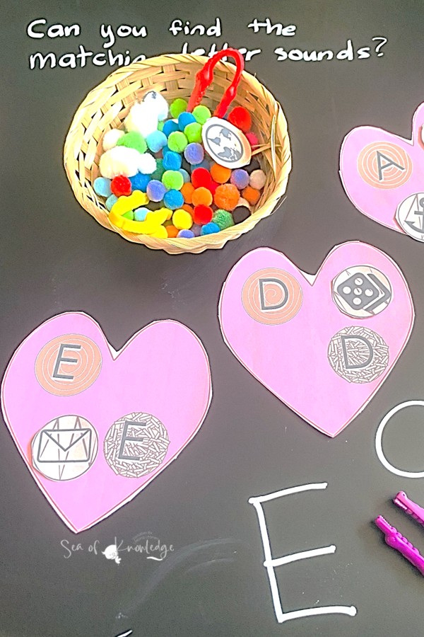 Kids playing with letter sound cards and chocolate heart printables in a Tuff Tray setup.