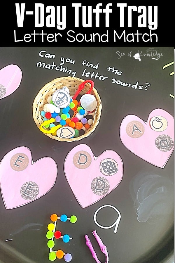 A colorful Valentine’s Day Tuff Tray filled with heart-shaped objects and sensory play materials.