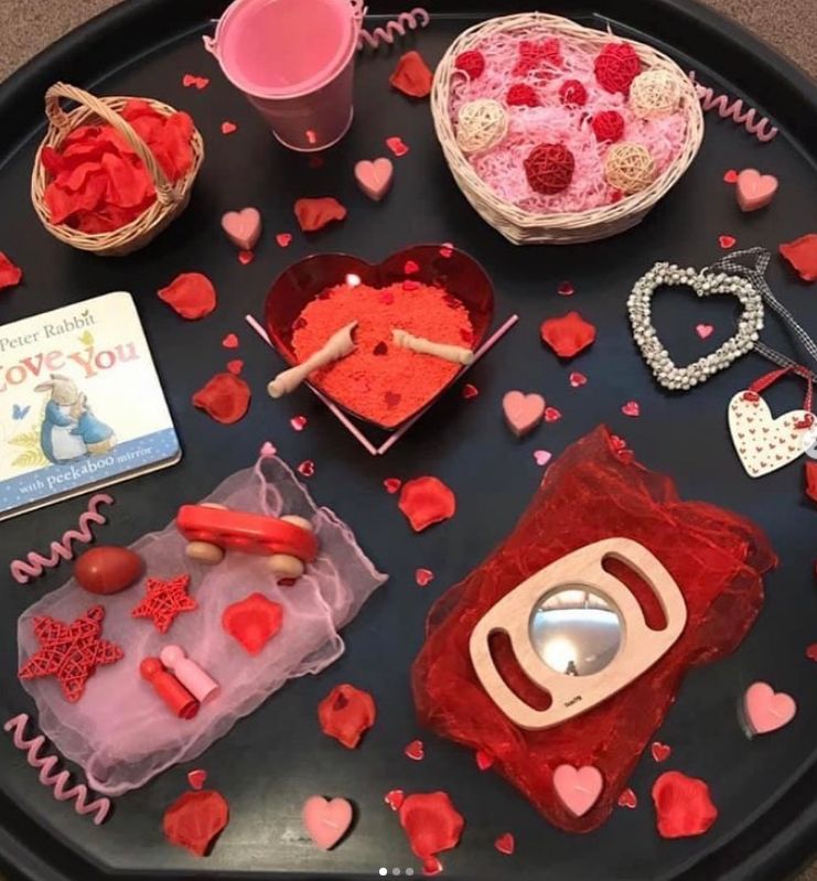 An overhead shot of a complete Valentine’s Day Tuff Tray setup, ready for toddler play.