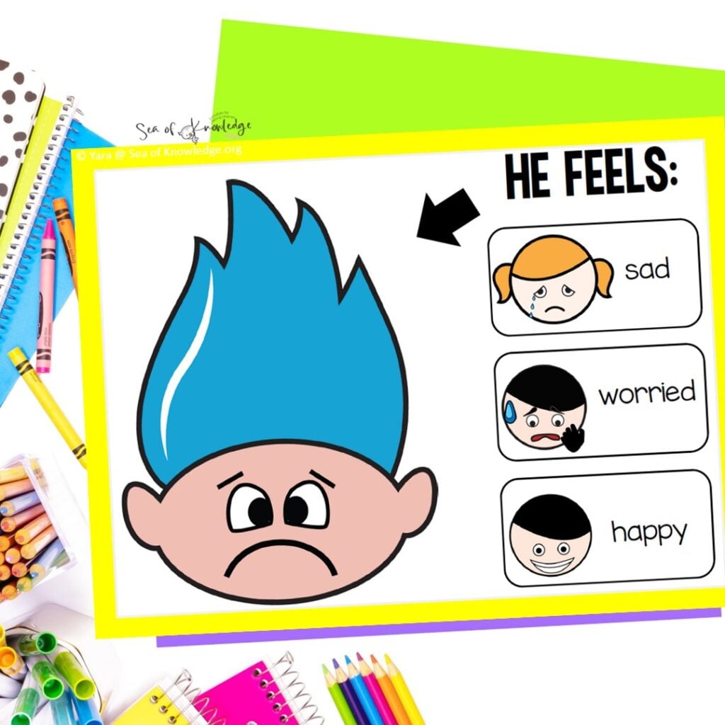 A set of colorful game cards featuring Trolls characters with various facial expressions, used to help students match characters with emotions like joy, fear, and sadness.