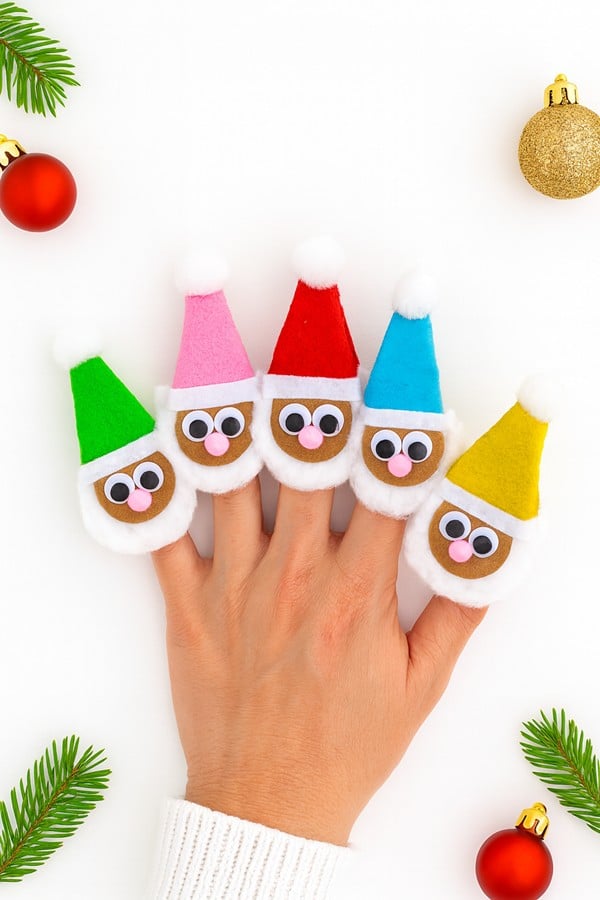 Egg carton finger puppet Santas painted red with mini cotton beards