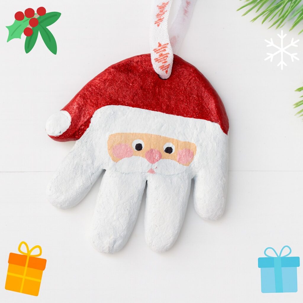 Salt dough Santa handprint ornament painted red and white with ribbon