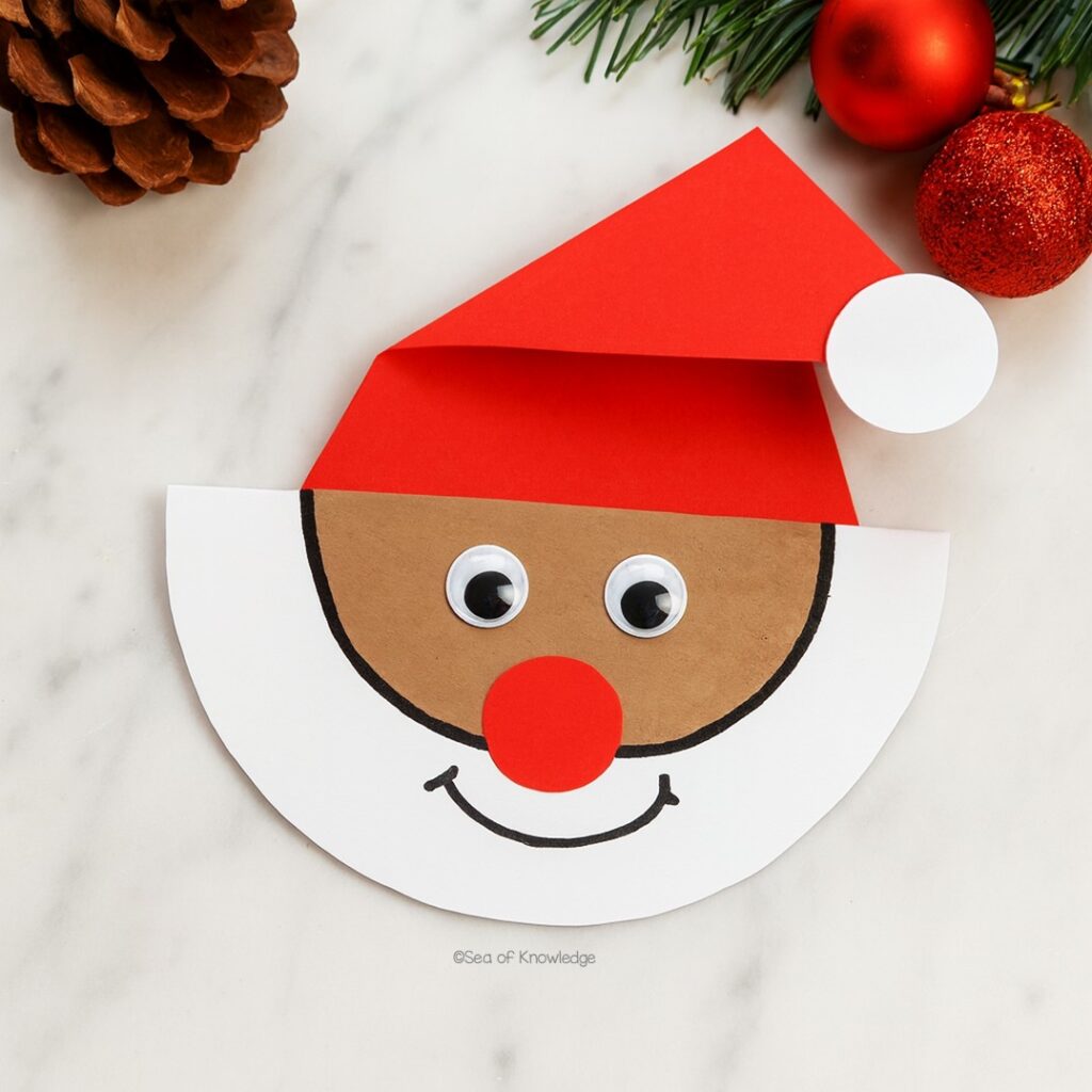 Rocking paper Santa craft on a curved base decorated with cotton beard and hat