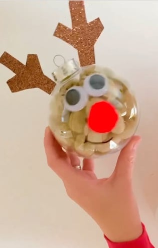 Clear reindeer Christmas ornament with googly eyes, a red nose, and antlers