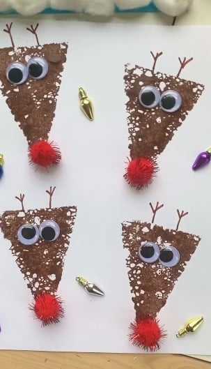 Triangular sponge reindeer decorations with googly eyes and red pom-pom noses