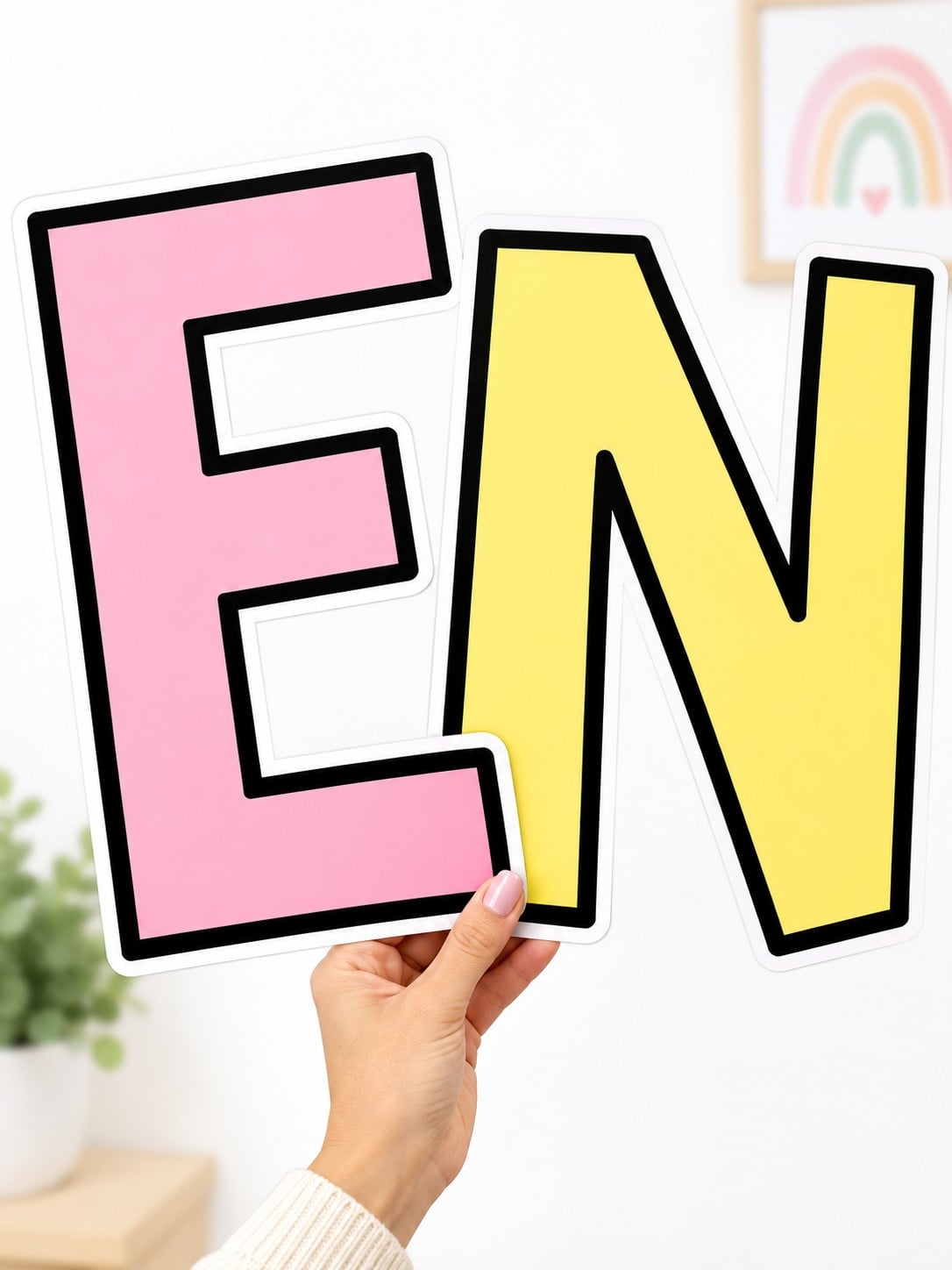 Large pink E and yellow N cutouts from the free printable bulletin board letters PDF.