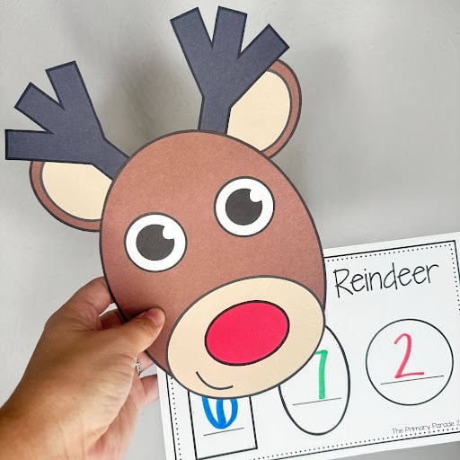 Paper reindeer craft above a worksheet with letter and number responses